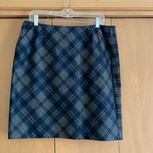 Lined plaid skirt with 2 side hip pockets.